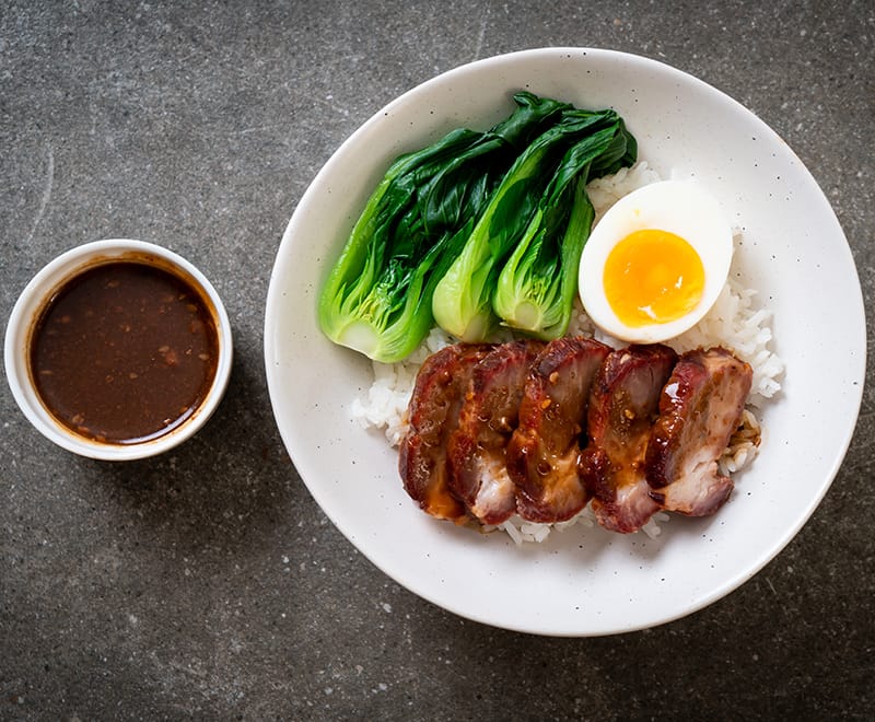 Char siu pork with rice and greens, a typical destination for export pork